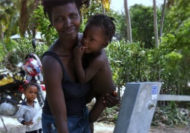 A Mother & Child Receive Water